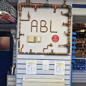 A room with pipes and a sign on the wall.